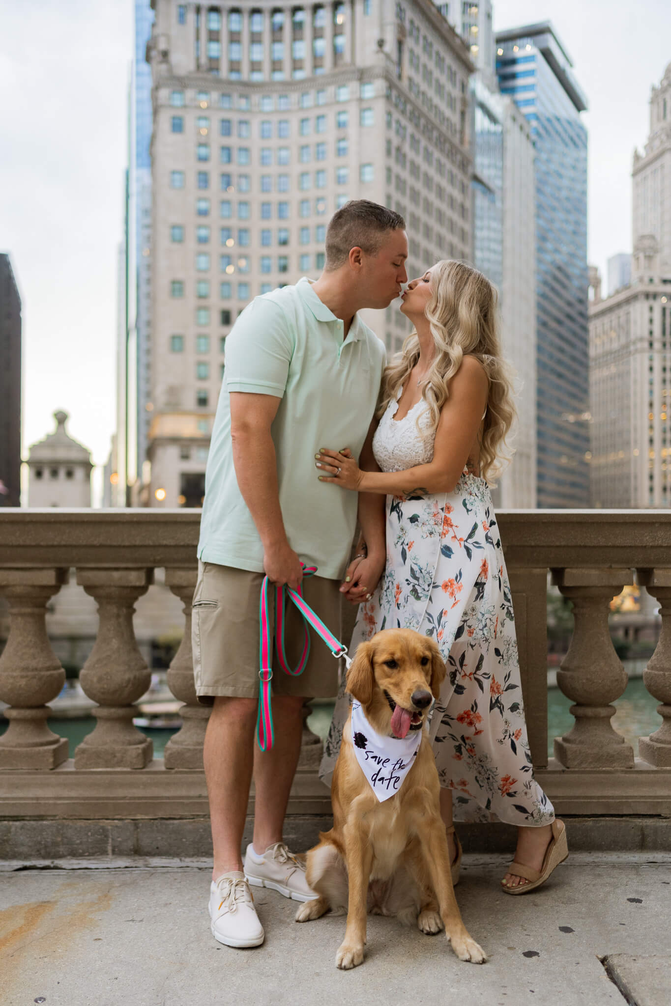 A heterosexual couple leans in for a kiss overlooking iconic downtown Chicago