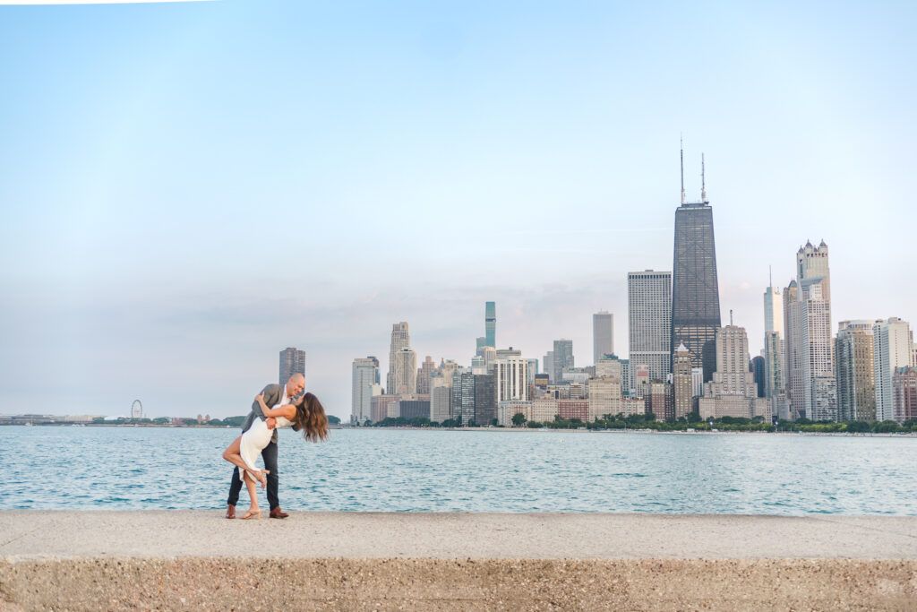 groom dipping his bride with the chicago skyline in the background during their Chicago elopement