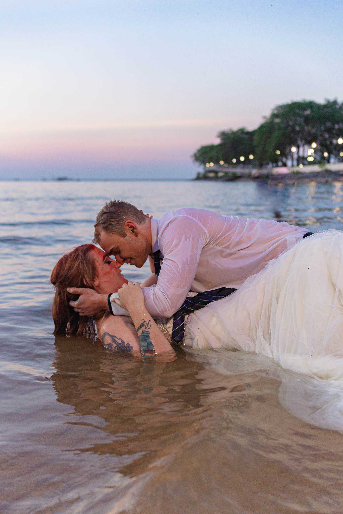 bride and groom laying in the water during their Chicago elopement