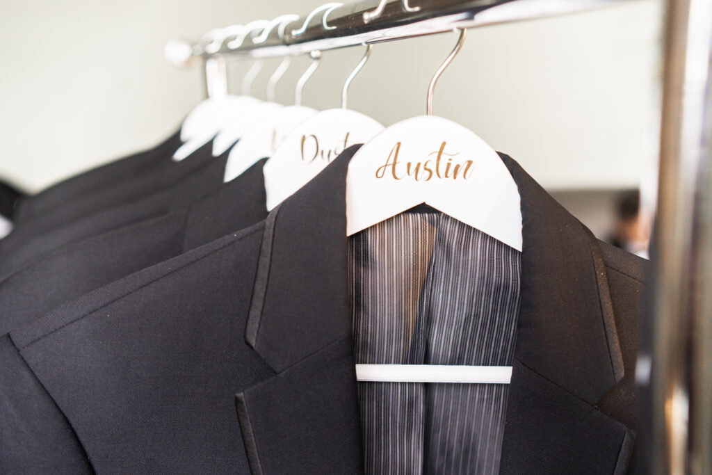 Tuxes on a clothing rack
