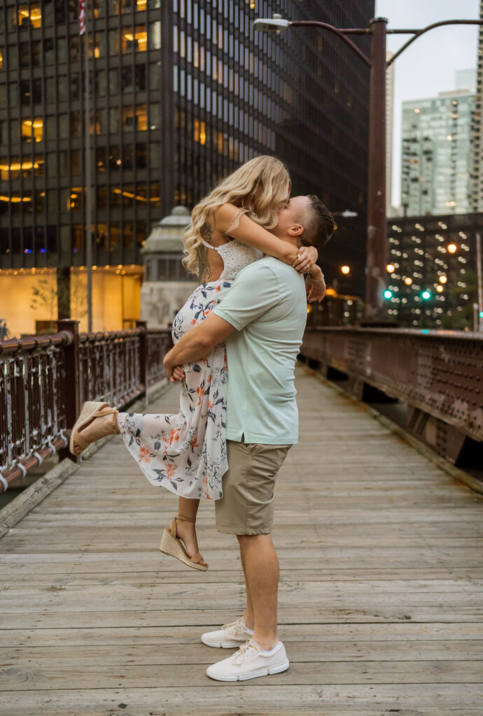 man lifting woman in the air and sharing a kiss Illinois Wedding Planners