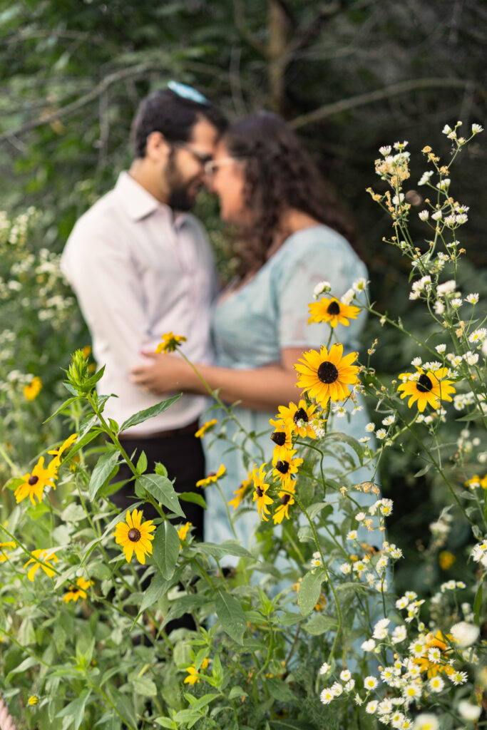 Jewish couple embracing in a sunflower field Zelda's Catering