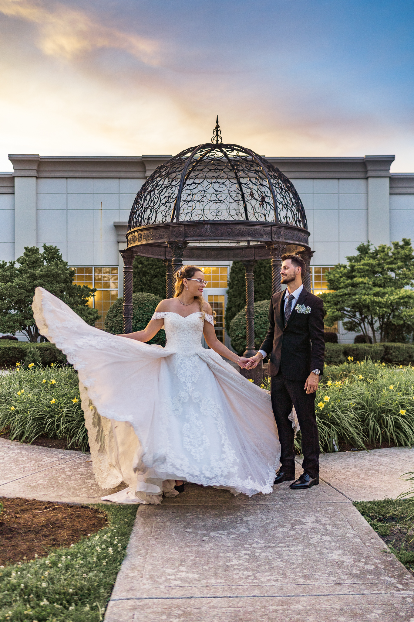 bride and groom standing in front of a gazebo Wedding Venues in Evanston