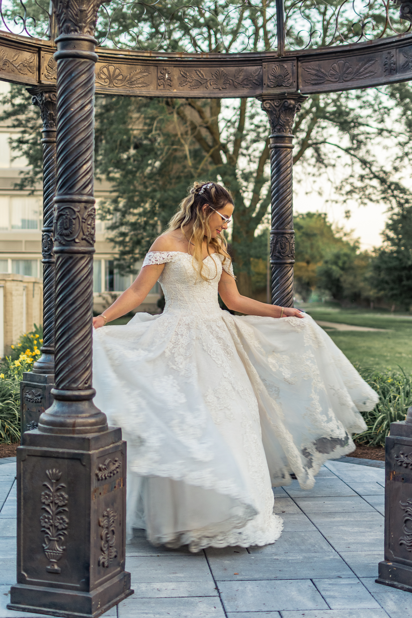 bride twirling in her gown under a gazeebo at her chicago wedding