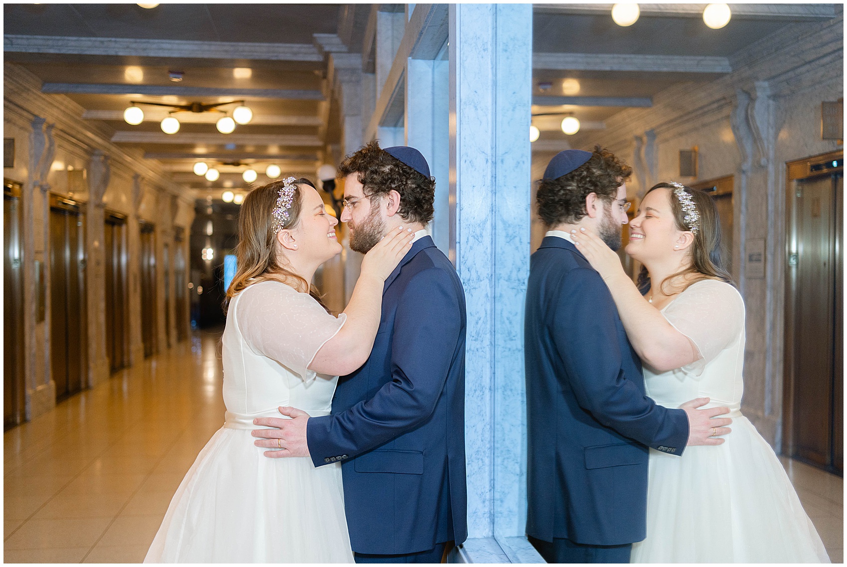 bride and groom smiling at each other with their reflection in the mirror at their Kimpton Gray Wedding