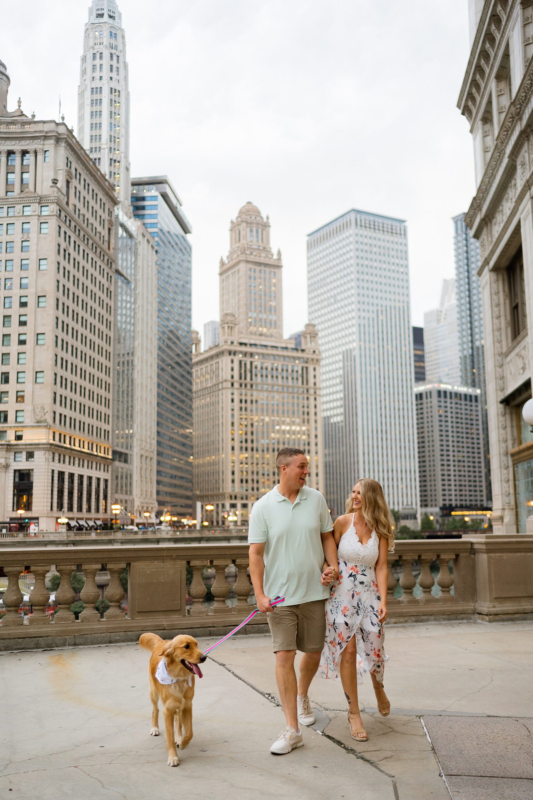 Couple walking with their dog in downtown chicago engagement photos