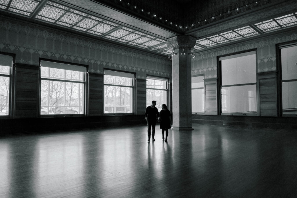 A couple walks towards the camera in the Chicago Board of Trade room at the Art Institute Chicago