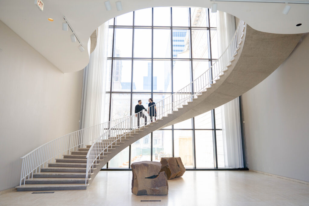 A couple stands on the grand staircase at their Art Institute of Chicago Wedding