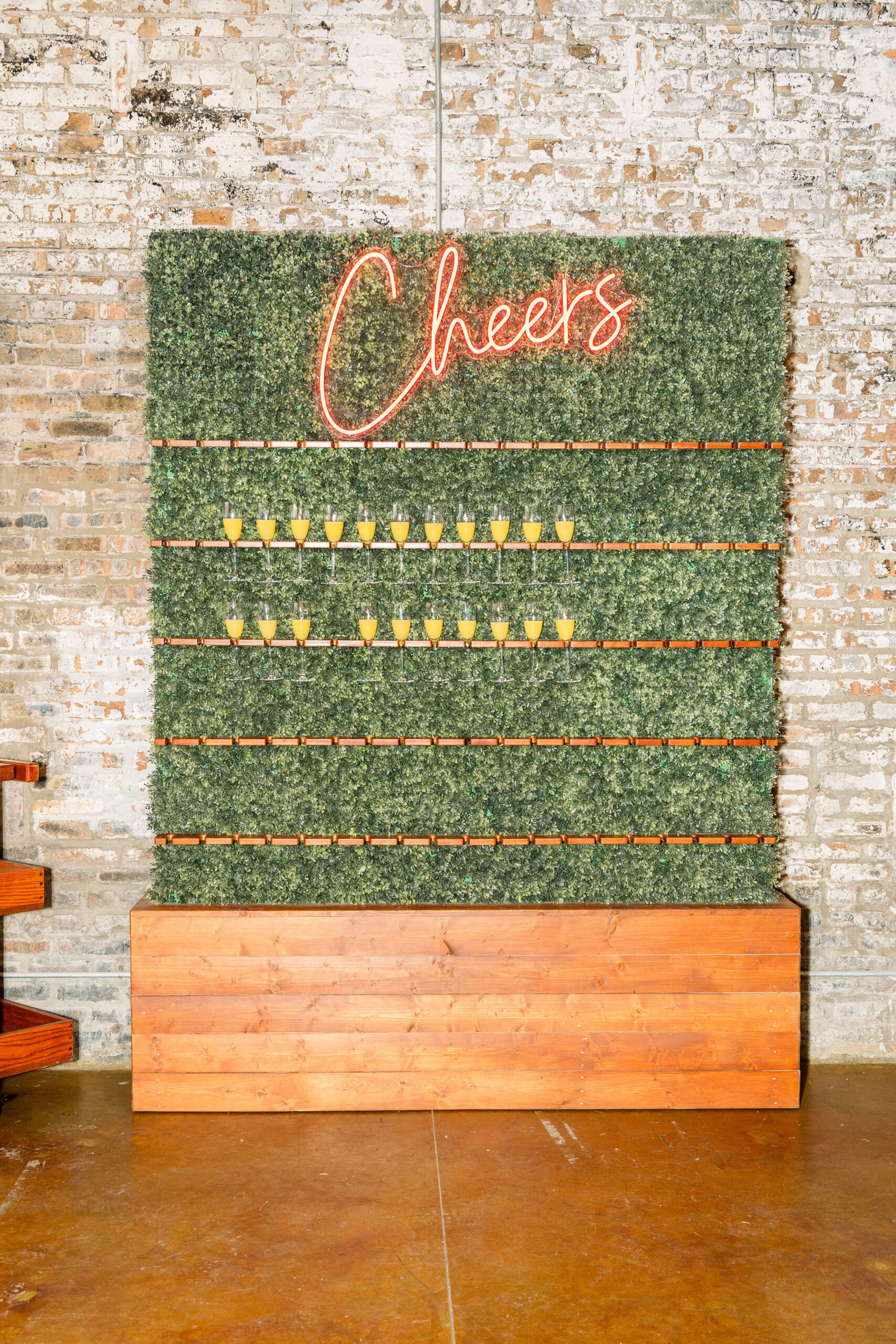 A champagne wall backed with greenery at The Carter Chicago