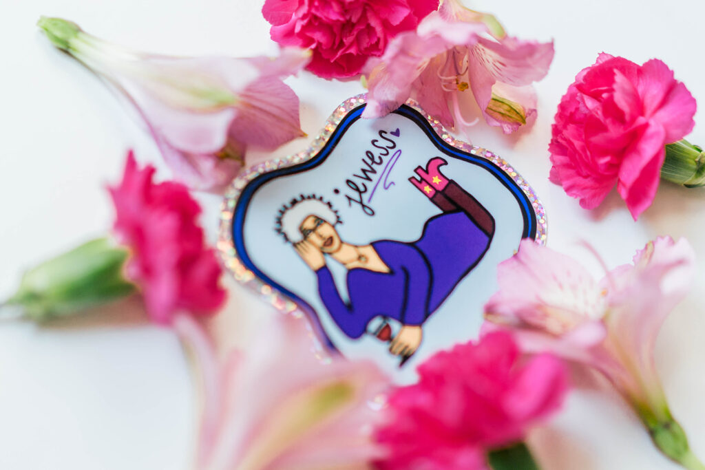 Jewish-themedsticker ("Jewess") surrounded by pink flowers