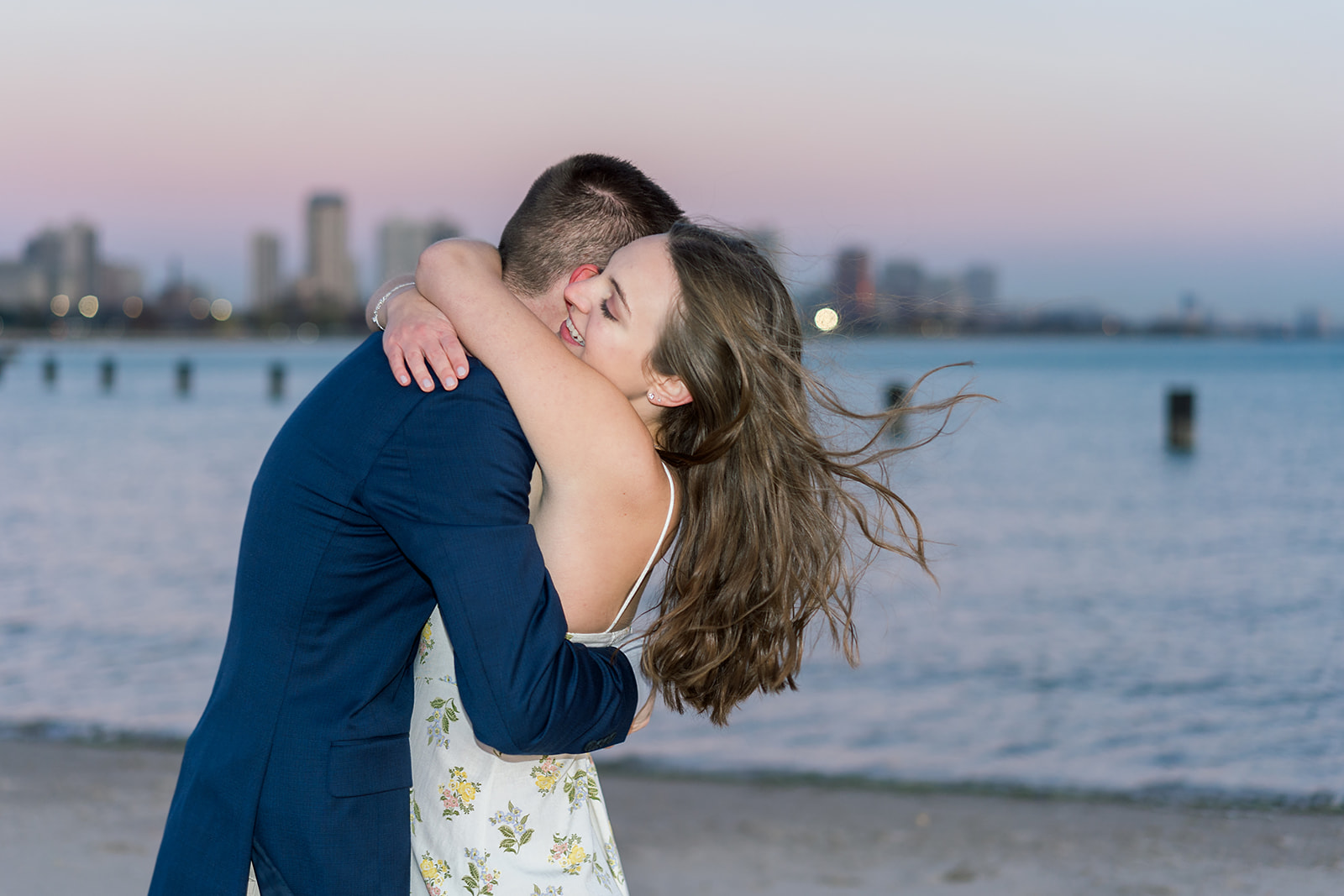 A chicago summer engagement session featuring a couple on the beach