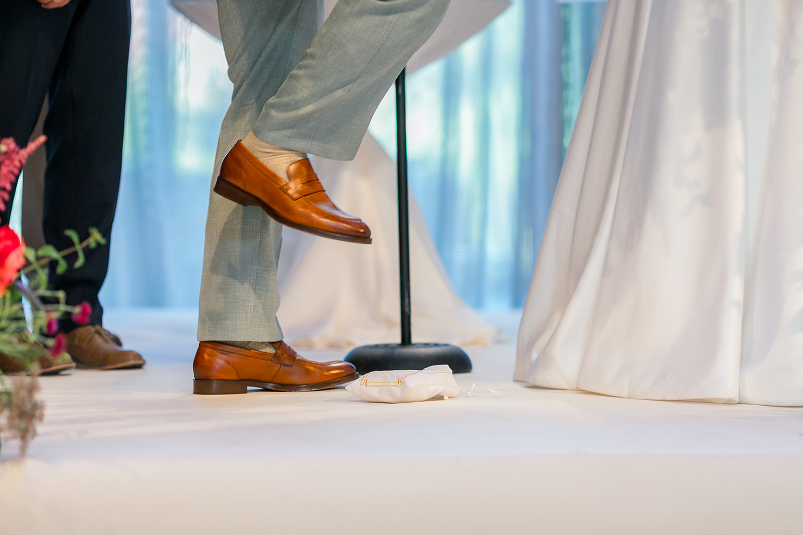 Details of a groom smashing the glass during his ceremony as outlined in the Jewish wedding photography guide